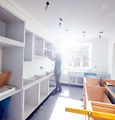 A fitted kitchen being installed.